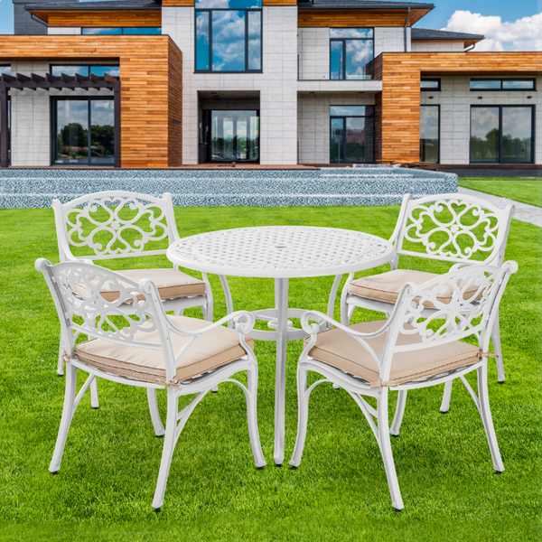 Marco Cast Aluminium 5 piece white Outdoor Setting in garden on a green grass with a house in the backdrop.