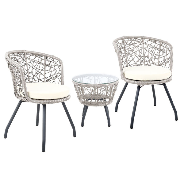 A three-piece outdoor bistro set comprising two high-backed chairs with beige cushions and a round rattan table with a clear glass top on a grey frame, set against a white background.