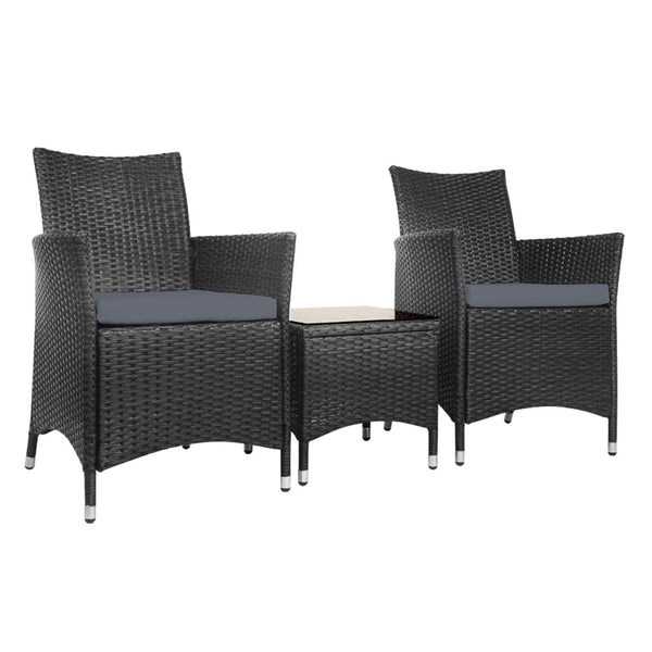 A three-piece outdoor bistro set consisting of two black wicker chairs with cushions and a matching black wicker side table with a glass top, set against a white background.
