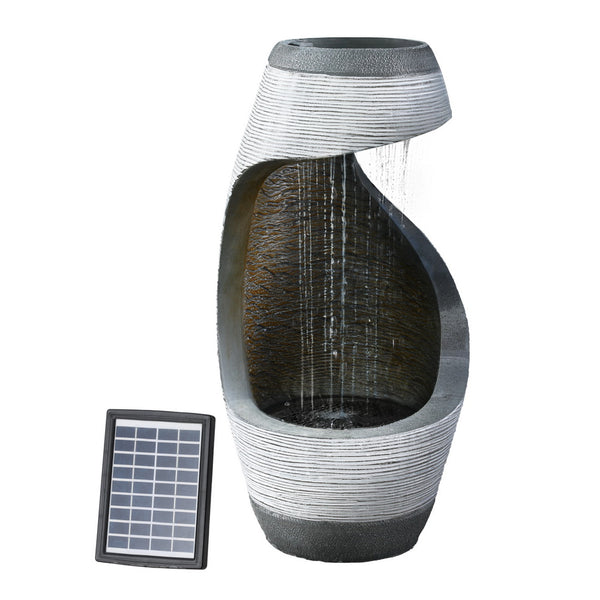 Solar-powered fountain with a cascading design, featuring a grey sculptural structure and a solar panel beside it, meant for outdoor garden use and set against a white background.