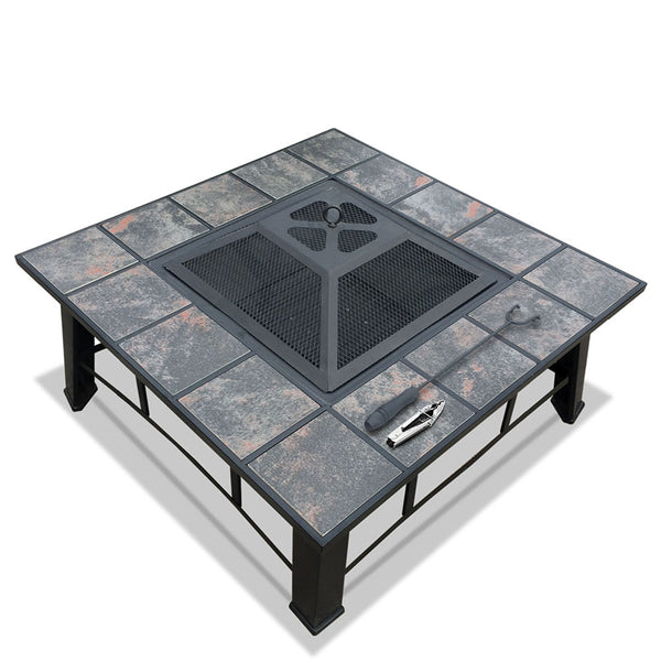 An outdoor fire pit BBQ grill with a grey finish, featuring a mesh dome, ice tray, and a BBQ grilling rack on top, set on a black steel frame with ceramic tiles on a white background.