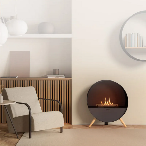Modern living room with a round fireplace and beige armchair.