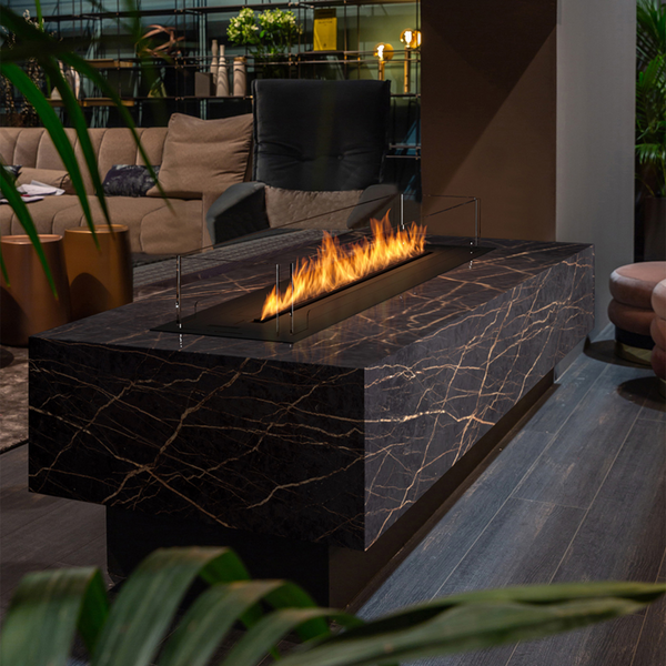 Modern indoor fire pit table with flames in a living room setting