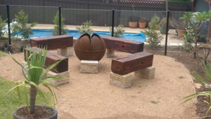 The Lotus Fire Pit in poolside garden setting