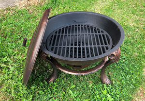 Top view of Vesuvius Firepit BBQ with Lid and grilling rack on a lawn