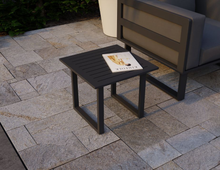 Load image into Gallery viewer, Vivara Outdoor Side Table in Charcoal colour with a magazine