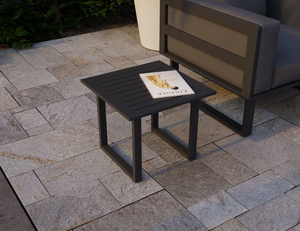 Vivara Outdoor Side Table in Charcoal colour with a magazine