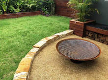 Load image into Gallery viewer, Cauldron 800mm Fire Pit in outdoor setting with BBQ grill