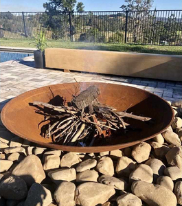 Cauldron 80cm Fire Pit in an outdoor area starting to burn