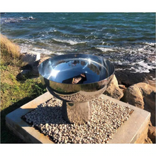 Load image into Gallery viewer, The Goblet Stainless Steel Fire Pit at the seaside on a 30cm high stand