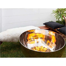 Load image into Gallery viewer, The Goblet Stainless Steel Fire Pit with small fire burning in garden setting