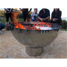 Load image into Gallery viewer, The Goblet Stainless Steel Fire Pit on the 15m stand with fire burning and people sitting around