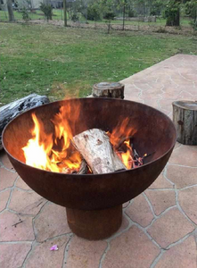 The Goblet Fire Pit with burning fire in garden