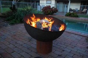 The Goblet Fire Pit at poolside with fire burning
