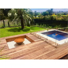 Load image into Gallery viewer, The Teppanyaki Fire Pit and lid in backyard beside a pool