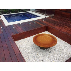 The Teppanyaki Fire Pit with lid on in backyard beside a pool