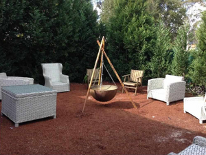 The Tripod Fire Pit in a garden setting