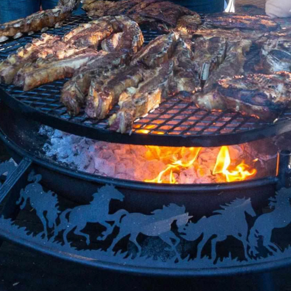Close up photo of the stockman design Ultimate BBQ Fire Pit with meat cooking on the top of the flames.