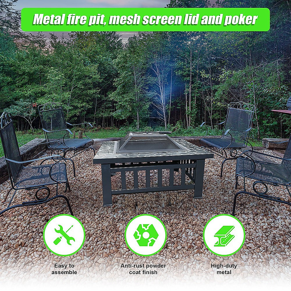 Square Metal Fire Pit Outdoor Heater set in a table with a mesh screen top with a faux-stone finish and set on a pebbled surface with 4 metal chairs inside wooden sleeper edging around the firepit, grass and trees in the backdrop. There are 3 inserted images showing easy to assemble, anti-rust powder coating and high duty metal.