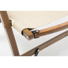 A close-up image of the base of a foldable outdoor camping chair made of bamboo, with beige base, and wooden frame.