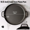 13.5-inch cast iron pizza pan with measurements on a white marble background