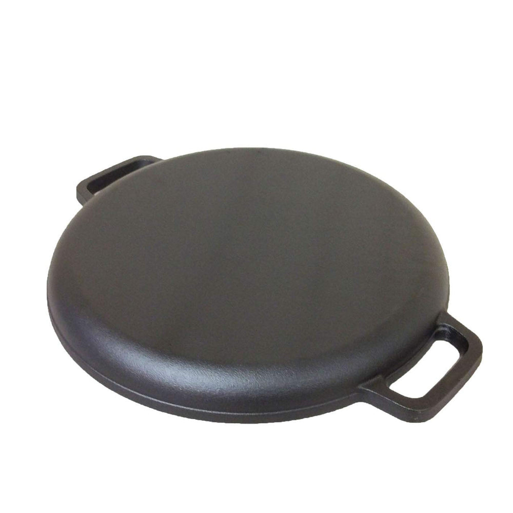 Black round pan upside down with handles on a white background