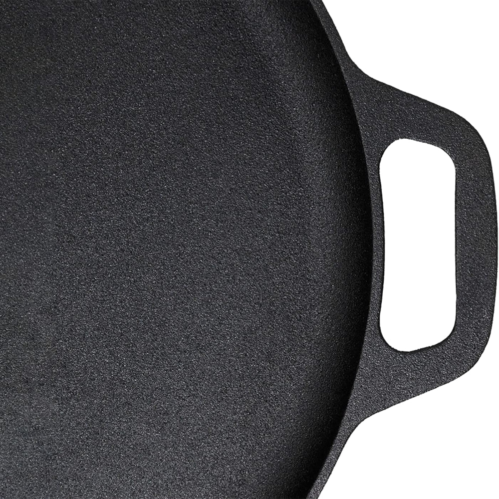 Close-up of a black cast iron skillet with a handle on a white background