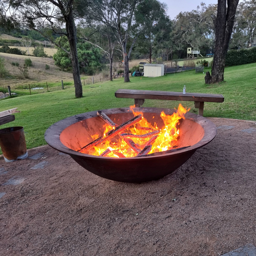 The Crucible Fire Pit with a fire burning in a country backyard - Hot Fire Pits Australia