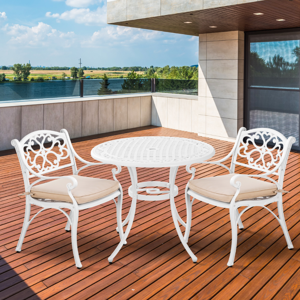 White outdoor furniture set with beige cushions on a wooden deck.