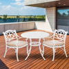 White outdoor furniture set with beige cushions on a wooden deck.