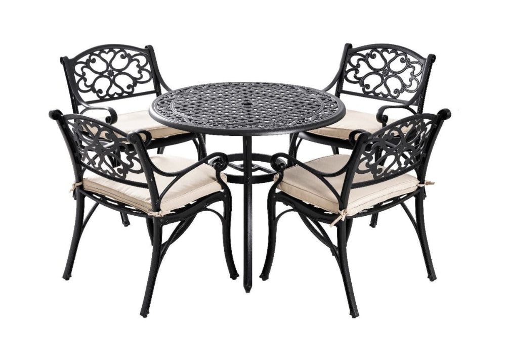 Outdoor dining set with a round table and four chairs on a white background