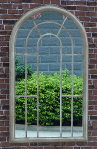Tracey Garden Window Mirror on brick wall with hedges in reflection