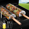 BBQ Grill baskets with vegetables on a grill, surrounded by cooking tools and oil bottle.