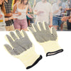 Pair of beige gloves with black dots on a white background, people in the background.