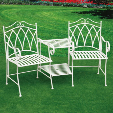A set of two white wrought iron outdoor chairs with a matching center table on a green artificial grass surface.
