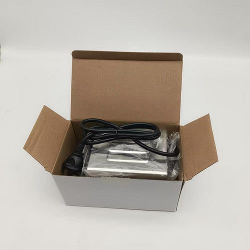 Open cardboard box containing electronic components on a white background.