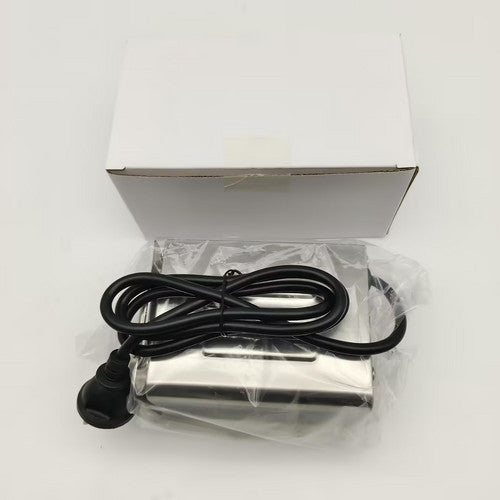 Metallic device with black cable on a white background.