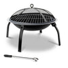 A portable black fire pit with a foldable design, featuring a mesh dome lid and a poker tool next to it, set on a white background.
