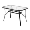Glass dining table with black metal frame on a white background