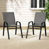 Two grey outdoor chairs on a patio with a neutral background