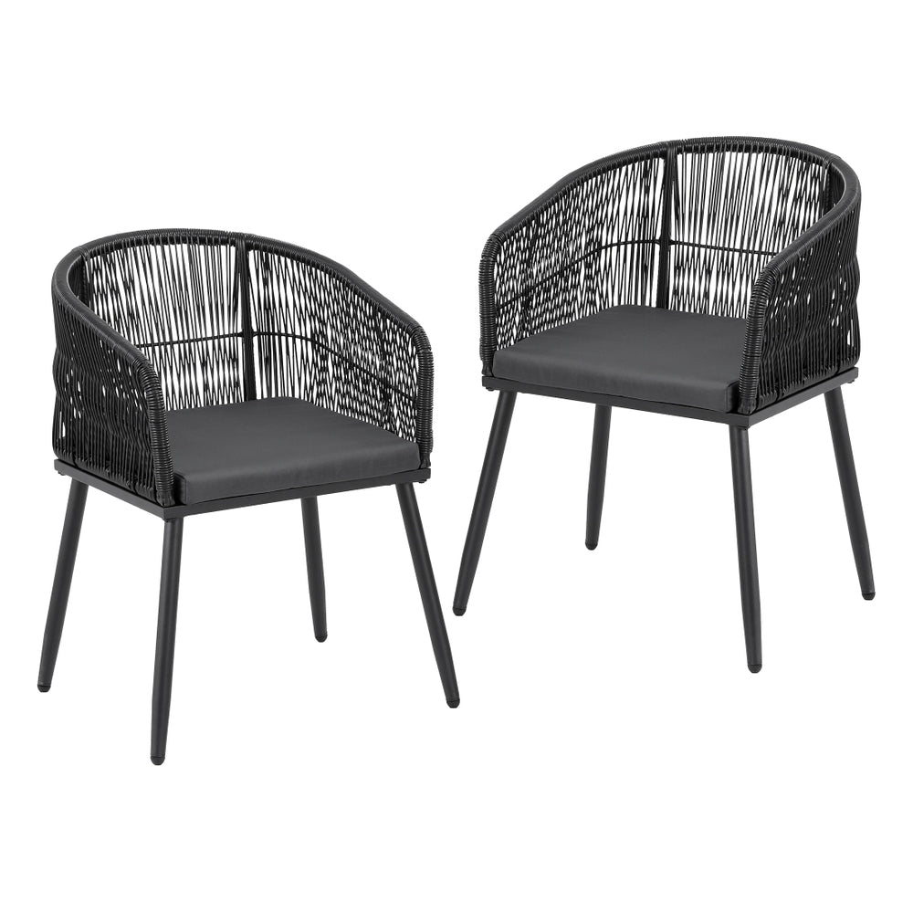 Two black wicker chairs with dark cushions on a white background