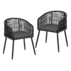 Two black wicker chairs with dark cushions on a white background