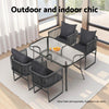Outdoor and indoor furniture set with a glass table and chairs in a room.