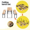 A folding outdoor furniture set consisting of a wooden tabletop and two matching benches with inset images showcasing that the pieces all fold up with locking hinges on a white background.