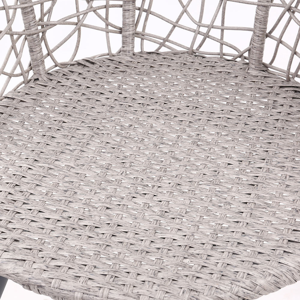 Close-up image of the seat part of a grey rattan chair showing its design and weaving and set against a white background.