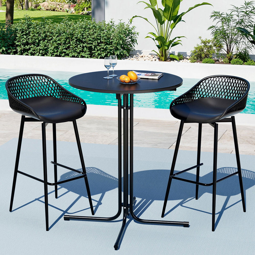 Black outdoor bar table with two stools by a pool