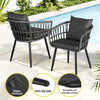 Two black outdoor chairs with cushions by a pool, featuring water-resistant, anti-slip feet, and removable washable cushion text.