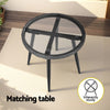 Round glass table with black metal frame on a wooden deck