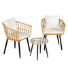 Two wicker chairs with white cushions and a matching table on a white background