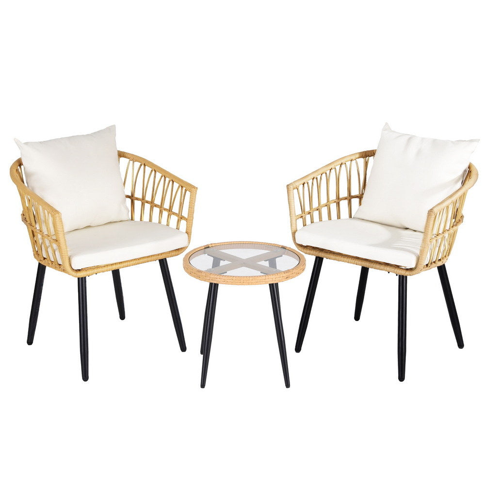 Two wicker chairs with white cushions and a matching side table on a white background